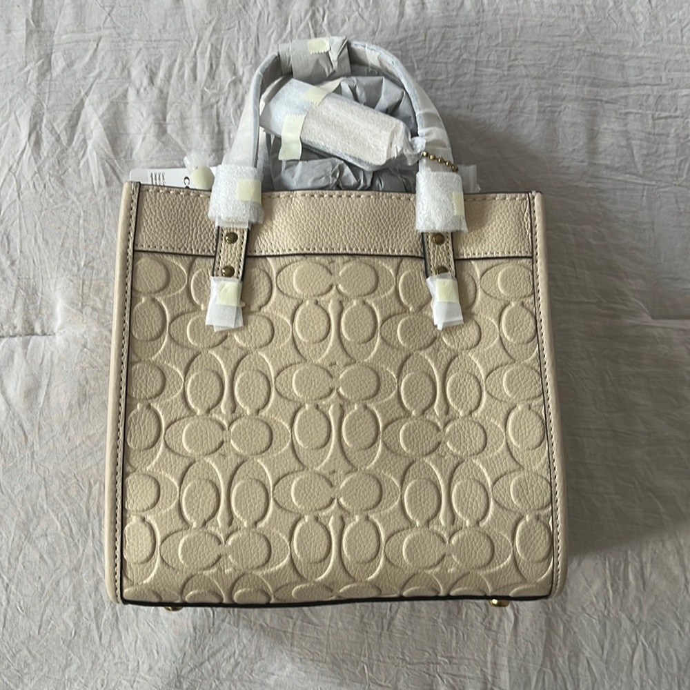 BRAND NEW COACH Bag on Embossed Ivory Leather signature logo. Brass details